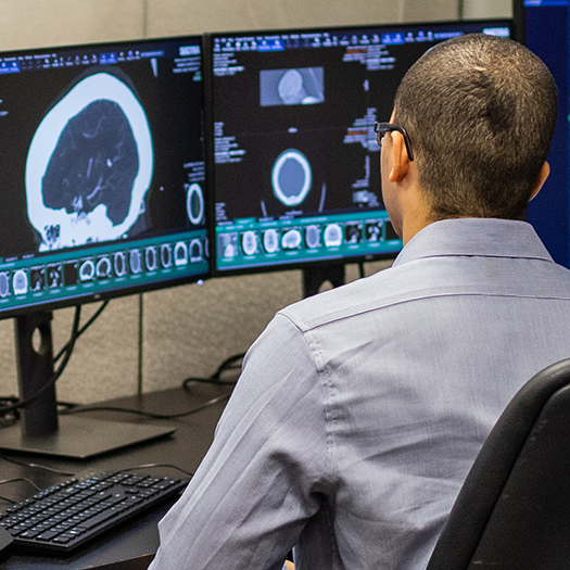 MIR Radiologist examining a scan in a reading room