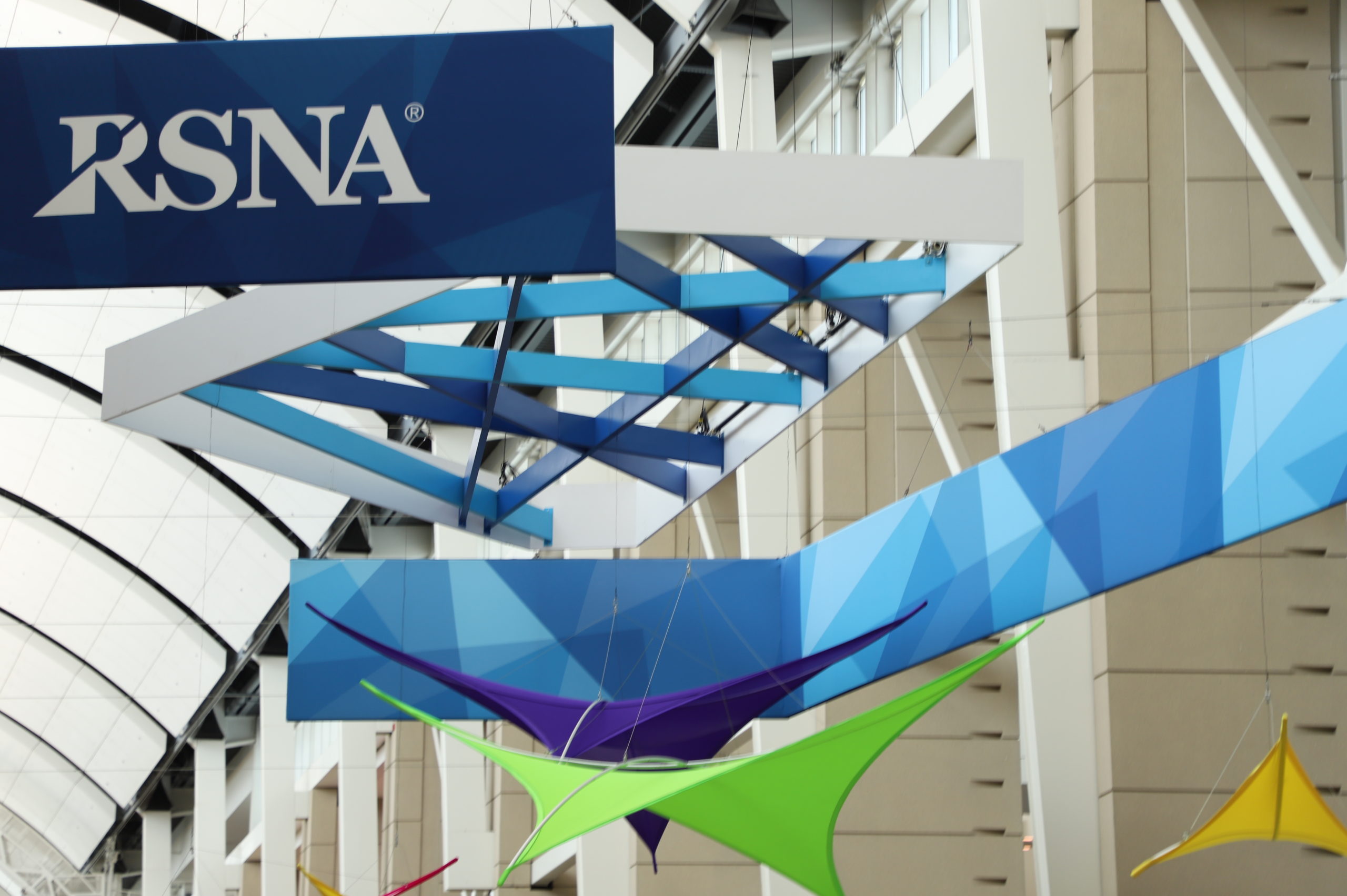 Branded signs and decorations hang from the ceiling of McCormick Place during the Radiological Society of North America's Annual Meeting in Chicago.