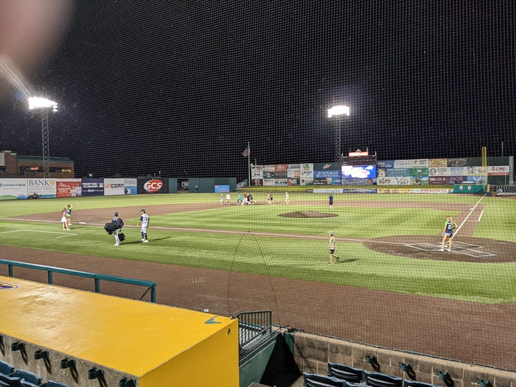 A long shot of GCS Credit Union Ballpark at night as members of the Benzinger Lab round second base.