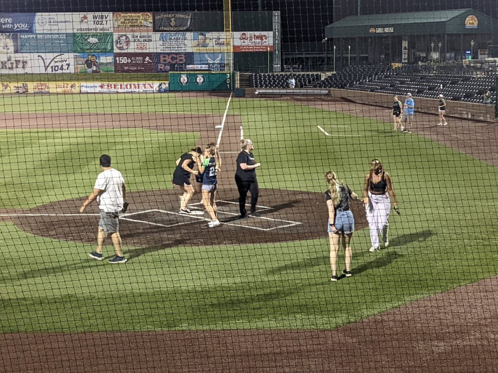 A group of Benzinger lab members cross home plate at GCS Credit Union Ballpark.