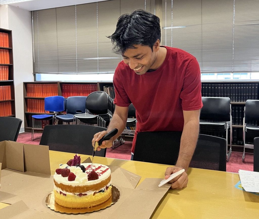 Dr. Bhuban cuts a birthday cake