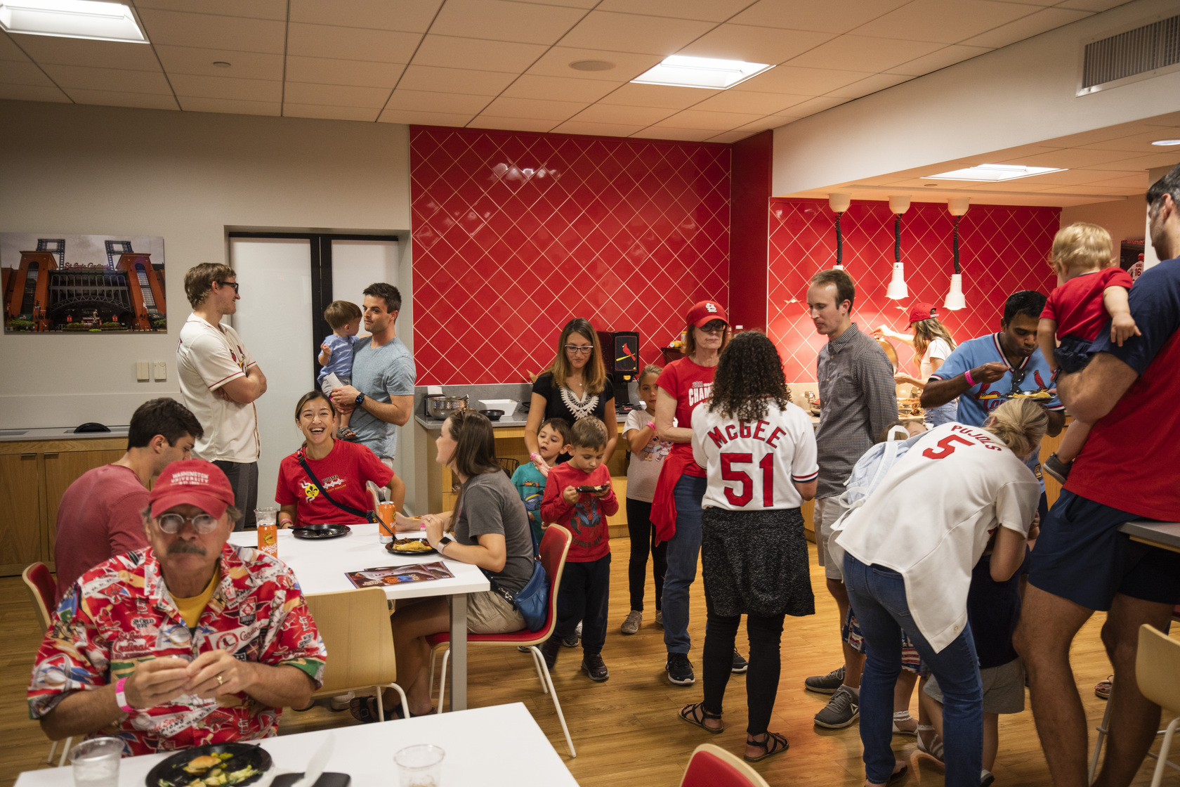 MIR faculty, trainees and families mingle at a party suite in Busch Stadium for a Cardinals game.