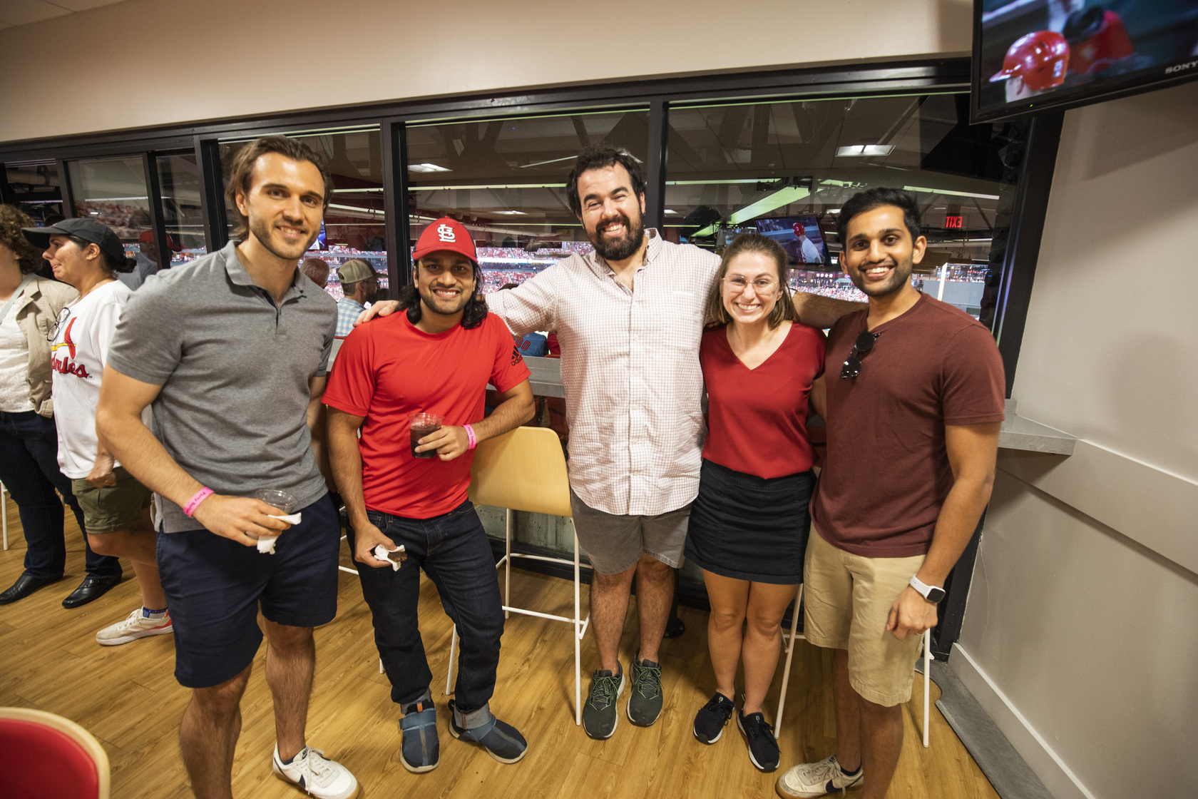 MIR faculty, trainees and families mingle at a party suite in Busch Stadium for a Cardinals game.