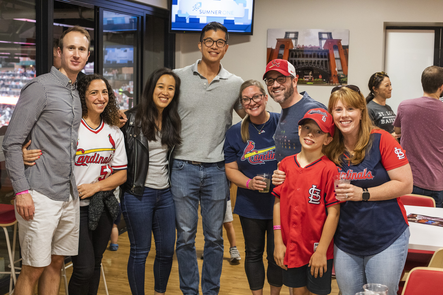 MIR faculty, trainees and families mingle at a party suite in Busch Stadium for a Cardinals game.