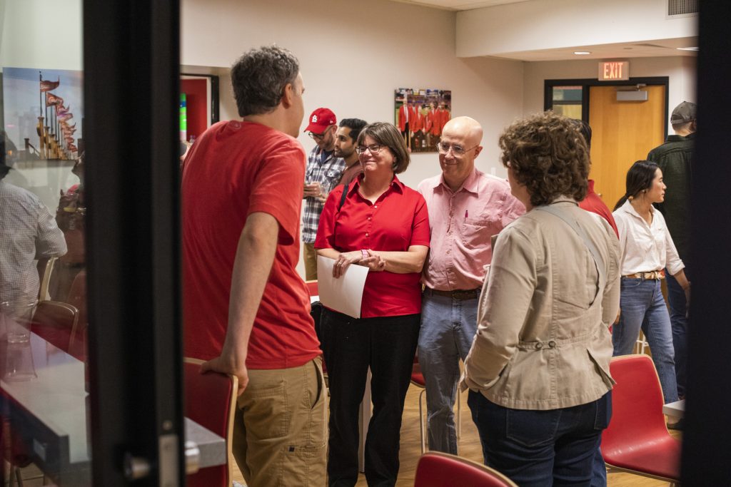 MIR faculty, trainees and families mingle at a party suite in Busch Stadium for a Cardinals game.