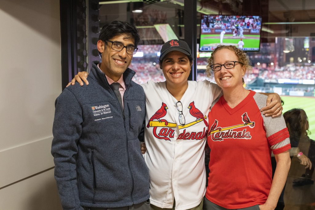 MIR faculty, trainees and families mingle at a party suite in Busch Stadium for a Cardinals game.