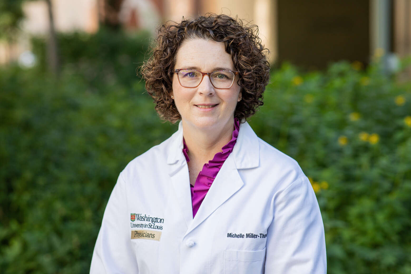 Outdoor headshot of Michelle Miller-Thomas, MD, wearing a white coat.