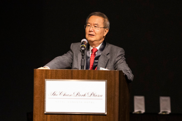 Joseph K.T. Lee, MD, stands at a podium at the 2022 Evens Society Alumni Weekend at the Chase Park Plaza.