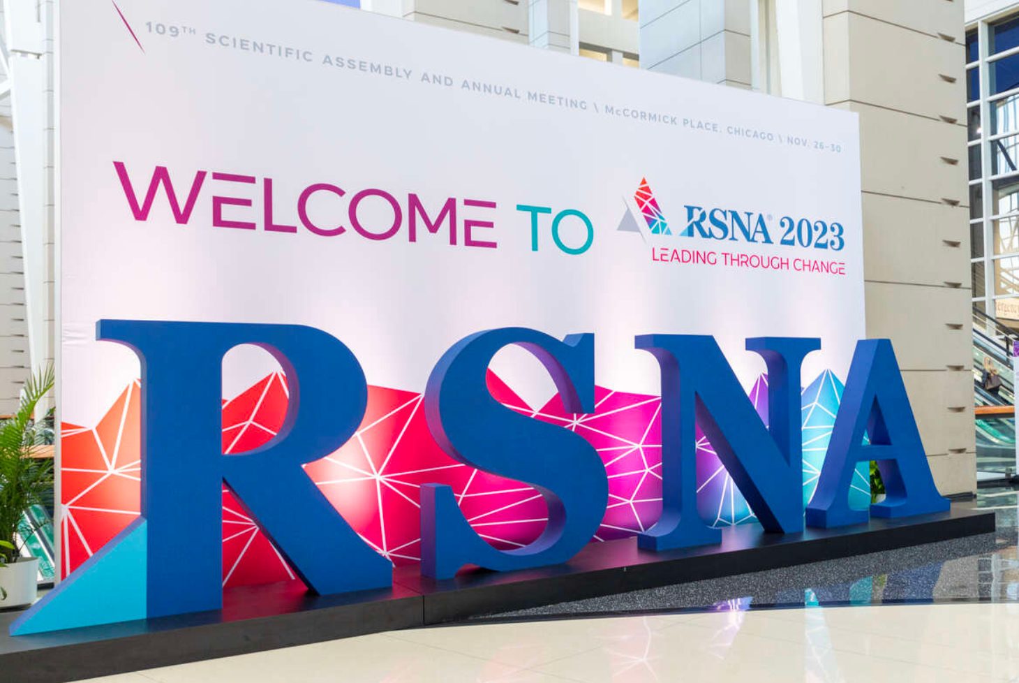 A sign reading "Welcome to RSNA 2023: Leading Through Change" with large letter props sits in the main entrance hall at the Radiological Society of North America's 109th Scientific Assembly and Annual Meeting at McCormick Place in Chicago, Illinois.