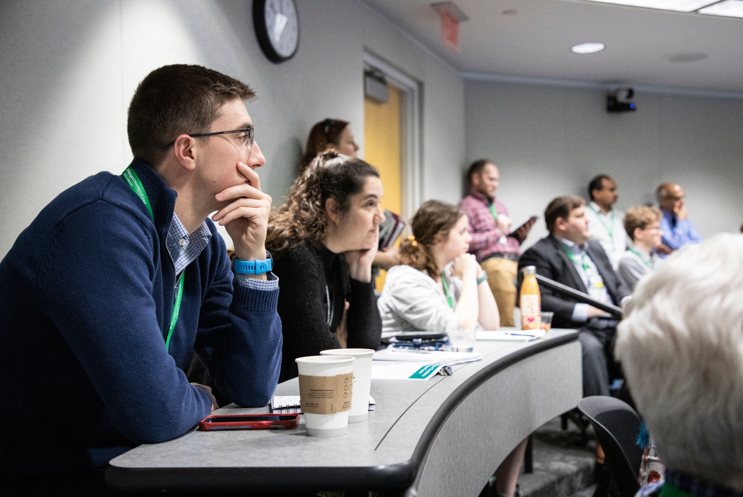 Attendees sit at a table and listen to a lecture at the 2024 PET-RTRC Annual Workshops and Scientific Session at Washington University School of Medicine in St. Louis.