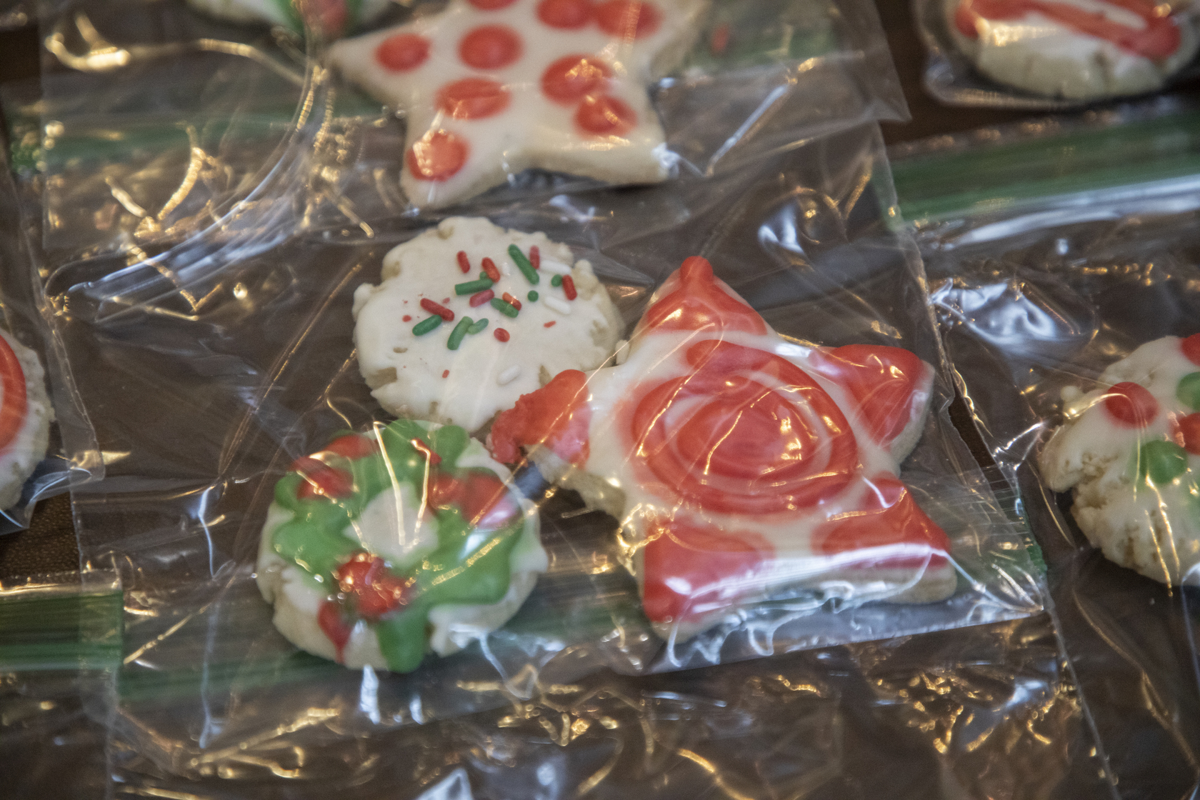 A close-up of red and green holiday-themed cookies.